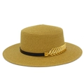 Detail view of woven boater hat featuring a black leather band and golden feather buckle - Brown