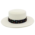 Detailed close-up of woven flat top Panama hat with colorful rhinestone studded ribbon - White