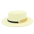 Detail of flat top straw hat with black band and golden metal leaf ornament - Off White