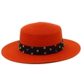 Detail of orange straw boater hat featuring colorful rhinestones on a black band - Red
