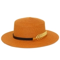 Detail of caramel straw hat with black leather band and golden leaf metal accessory - Caramel color