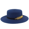 Close-up of a navy boater hat with fine woven texture and a gold leaf metal ornament - Dark Blue