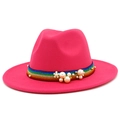 Detail of fuchsia wool fedora with rainbow striped band, white pearls, and flower accent - Rose Red