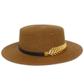 Detail of a brown woven straw boater hat with black band and gold leaf metal accessory - Coffee