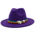 Close-up of purple wool fedora hat featuring rainbow striped ribbon and pearl accents - Purple