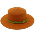 Close-up of rust orange woven straw hat with a vibrant green leather band and gold buckle - Caramel color