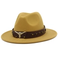 Close-up of mustard yellow fedora featuring a leather band and golden longhorn skull ornament - Khaki