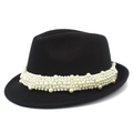 Detail of elegant black wool Fedora hat featuring luxury white pearl embellishments around the base - Black