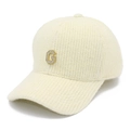 Detail of knit baseball cap with rhinestone letter G and warm cream yarn texture - White