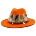 Detail view of orange felt fedora with ethnic woven band, feathers and metal coin pendants - Orange