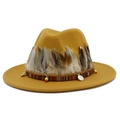 Detail of yellow fedora hat featuring natural feathers and ethnic woven band accents - Khaki