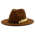 Detail of a brown fedora hat featuring a black band and a golden feather metal ornament - Coffee