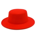Close-up of bright red wool felt flat top hat featuring fine texture and minimalist design - Red
