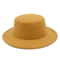 Detailed texture of mustard yellow wool felt boater hat with flat top and wide stiff brim - Camel