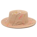 Detail of artistic paint splatter design on a flat top khaki straw sun hat brim - Pink