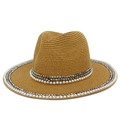 Close-up of khaki straw hat featuring elegant white pearls and silver rivet decorations - Brown
