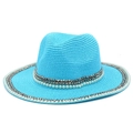 Close-up of pearl and rivet trim on a sky blue straw fedora hat with fine weaving - Blue