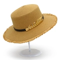 Detail of flat top straw hat featuring a black ribbon and gold leaf metal accessory - One Size / Brown