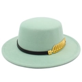 Detail of mint green boater hat featuring a black band and golden leaf ornament - Mint Green