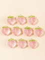 Macro shot of 10 pink resin peach charms with green leaves and metal rings for DIY jewelry - Pink Peach