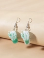 Close-up of creative 3D ice cream sundae earrings with green milkshake and straw detail - Green