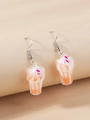 Close-up of creative ice cream sundae earrings with orange jam and cream resin details - Yellow White Red