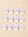 Macro shot of twelve mini resin flip-flop charms with purple straps for DIY jewelry crafts - Purple