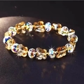 Détail macro de perles papillon en cristal ambré et perles irisées sur un bracelet perlé - Marron