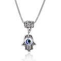 Minimalist Hamsa hand and Evil Eye pendant necklace with vintage silver finish on white background - Hamsa Hand