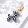 Detail of a dark gray resin balloon dog keychain with a gold metal spring clasp - Dark Gray