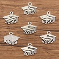 Detailed macro view of silver 2026 graduation cap alloy charms for DIY jewelry making - 2026 Graduation Cap Style