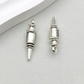 Detailed close-up of two antique silver alloy syringe charms with engraved scale markings - Medical Syringe (10606) / 7*26mm