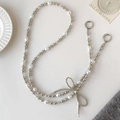 Crossbody phone chain with white pearls, silver beads and a beaded ribbon bow detail - Pearl Bow Beaded Long Chain