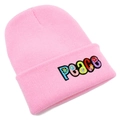 Close-up of pink knit beanie featuring colorful PEACE embroidery with floral details - Pink