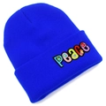 Detail of colorful PEACE embroidery with floral patterns on bright blue knit beanie - Sapphire Blue