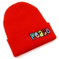 Detailed close-up of red knit beanie featuring colorful PEACE embroidery with floral patterns - Red