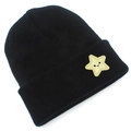 Close-up of black star embroidery patch with smiley face on knit beanie cuff - Black