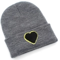 Detail of grey knitted beanie with a black glitter heart patch on the folded cuff - Marl Grey