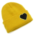 Close-up of bright yellow knit beanie featuring a black heart patch with gold sequins - One Size / Yellow