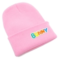 Close-up of pink knit beanie with colorful Bunny embroidery and ribbed texture - Pink