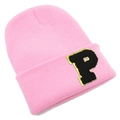 Close-up of pink knit beanie featuring a black letter P patch with gold glitter details - Pink