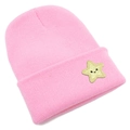 Detailed knit texture of pink beanie with a yellow smiley star patch on the folded brim - Pink