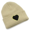 Detailed view of beige knit beanie featuring a black heart patch with gold glitter edges - Beige