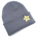 Close-up of a dark grey knitted beanie featuring a bright yellow star smile embroidery - Gray
