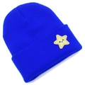 Detail of bright blue knitted beanie with yellow star smiley face embroidery patch - Sapphire Blue