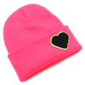 Close-up of pink knit beanie with black heart patch and gold sequin accents - One Size / Deep Pink