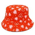 Close-up of red bucket hat with white hearts and Love, Be Mine, Hug & Kisses slogans - Red Valentine's Day Heart Slogan (Style 3)