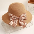 Elegant straw sun hat with ribbon bow featuring Happy letters on a stylish white basket - Brown