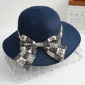 Detail of navy blue straw sun hat featuring a striped bow with HAPPY and ALWAYS text - Dark Blue