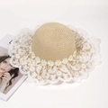 Detailed macro view of the beige woven straw hat with lace brim and small white daisies - One Size / Khaki